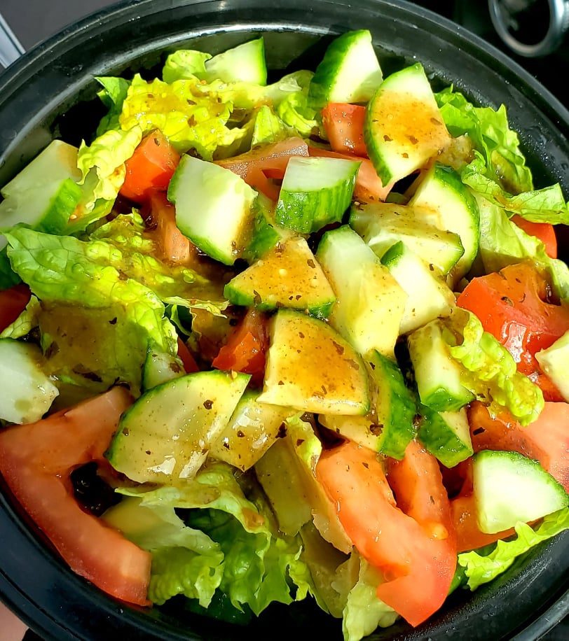 Salad of lettuce, tomatoes and cucumber with balsamic dressing